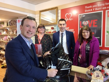 Front of till Alun Cairns MP, behind the till from left to right: Emma Harris BHF Assistant Shop Manager, Adam Fletcher, Head of BHF Cymru, and Pam Bear Volunteer.